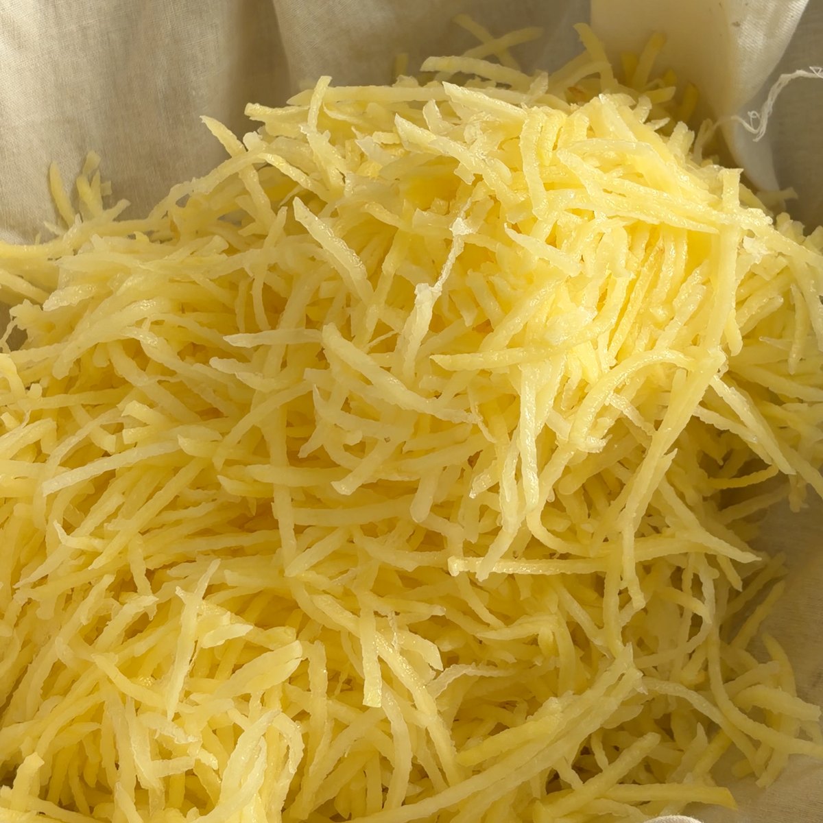 A batata ralada dentro do pano de linho, pronta a ser torcida
